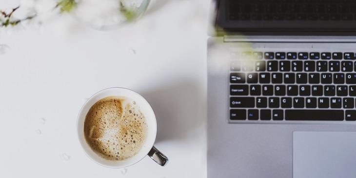 A computer and a cop of coffee