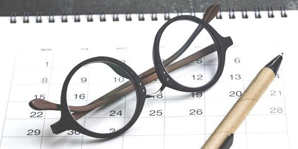 Glasses, calendar and pencil