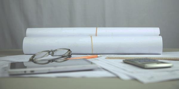 Documents, glasses and calculater on table