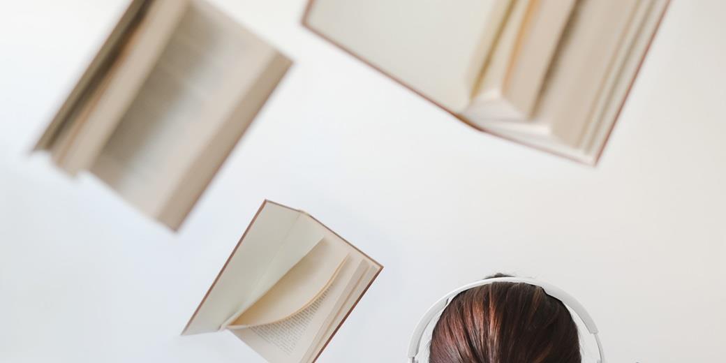 Books flying around a student