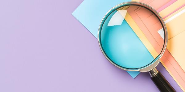 Papers and a magnifying glass
