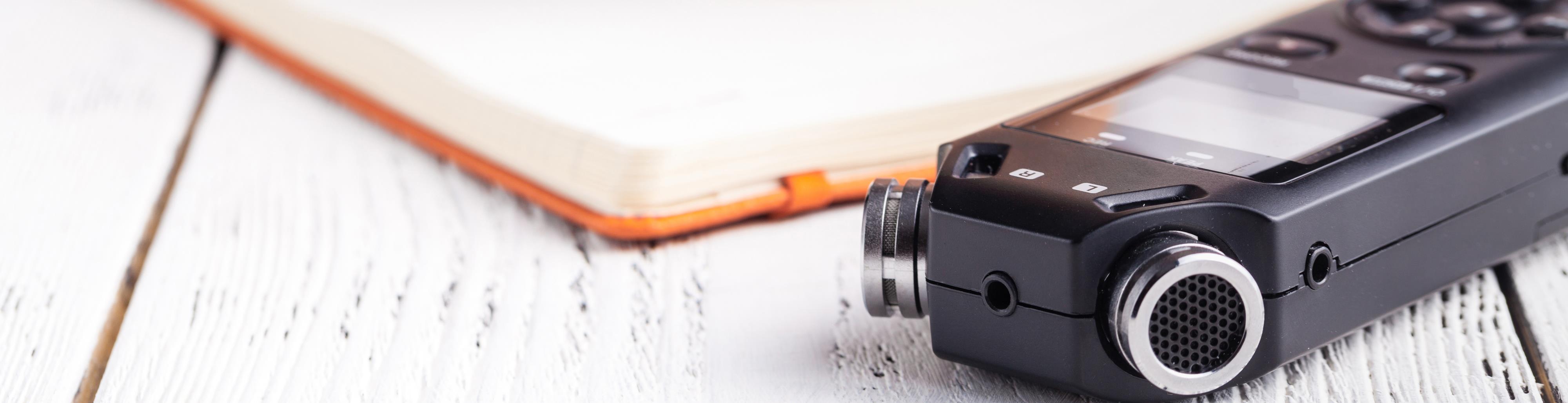 A dictaphone and a notebook