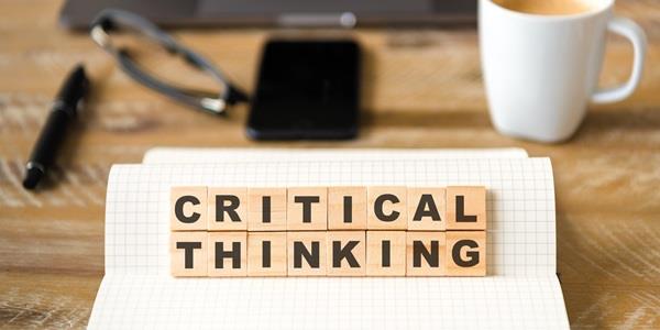 Letters saying critical thinking on a work desk