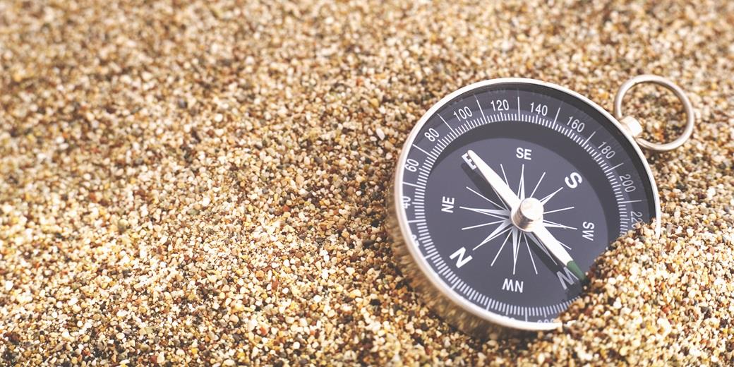 a compass lying in sand