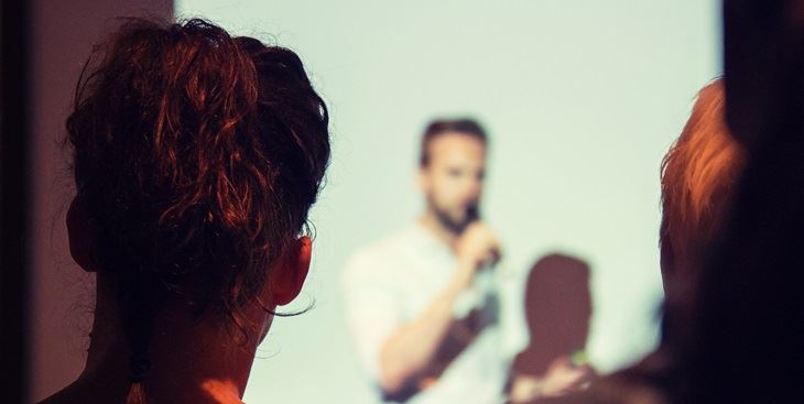 A man talking in front of an audience
